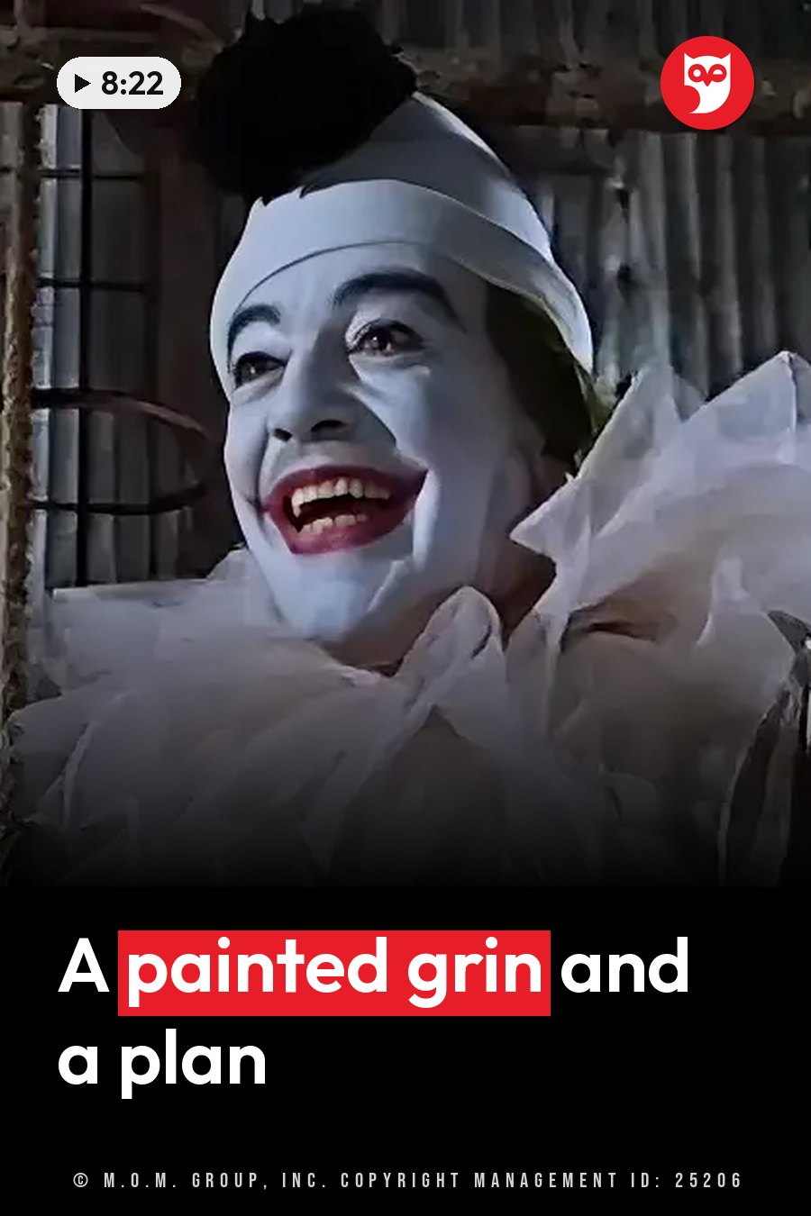 A performer in white face makeup, red lips and a dark hairpiece smiles widely in a ruffled clown collar. A headline runs in white letters across the lower third.