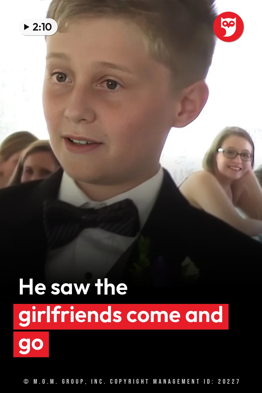 A young boy in a tuxedo with a bow tie and a boutonniere sits at the event and looks ahead. A headline runs in white letters across the lower third.