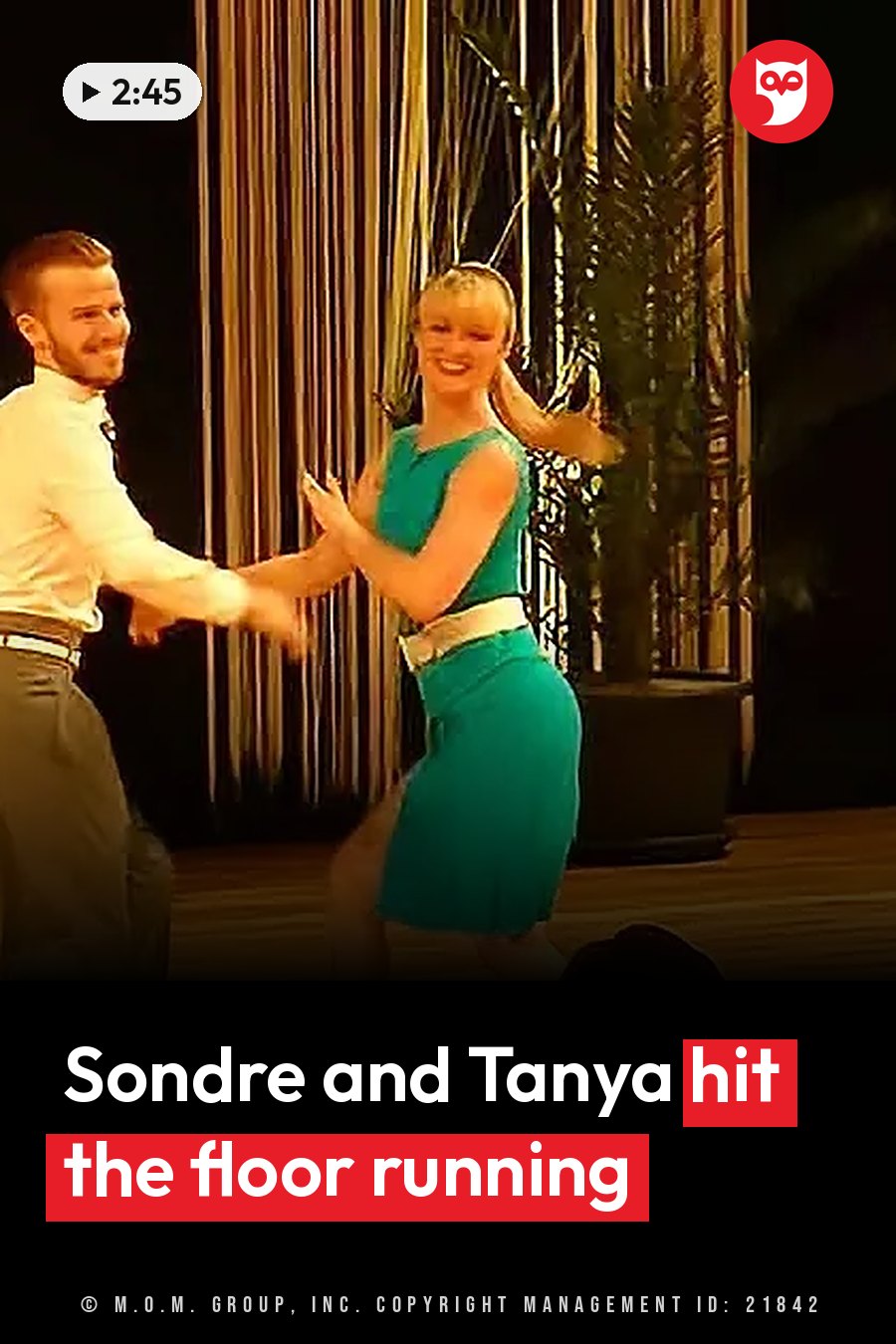 A man and a woman dance together on a wooden floor near curtains and a potted plant. A headline runs in white letters across the lower third.