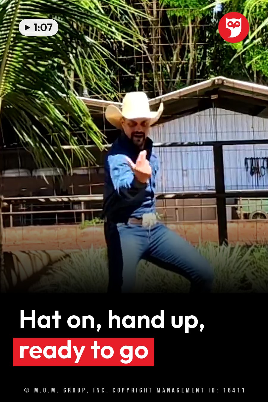 A man in a cowboy hat and jeans stands outdoors near a fence and a palm tree, gesturing with one hand. A headline runs in white letters across the lower third.