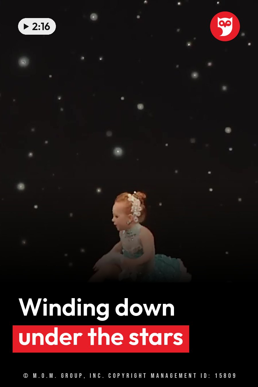 A young child in a light blue dress sits on a stage under starry lights. A headline runs in white letters across the lower third.