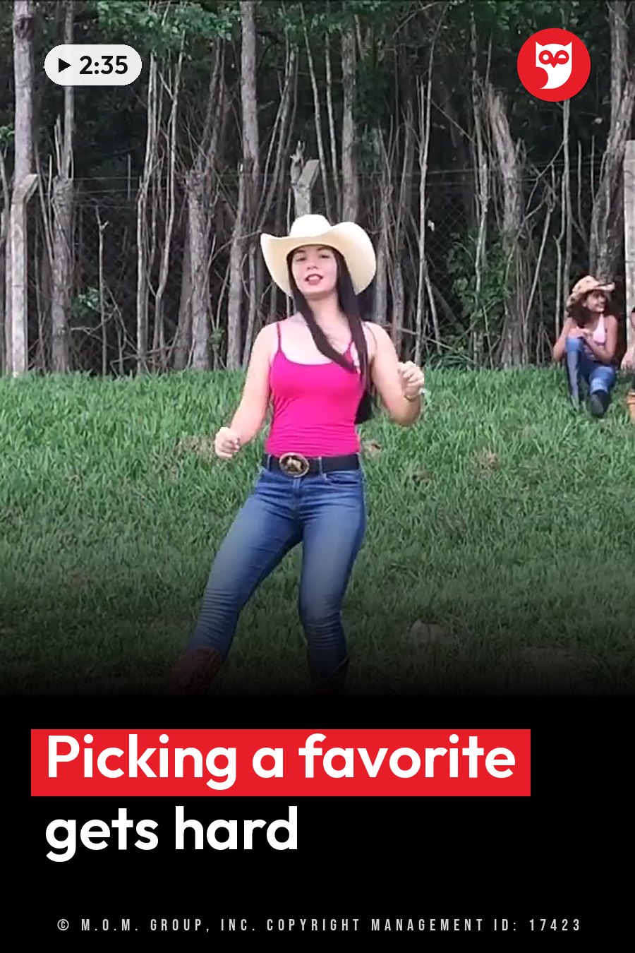 A woman in a cowboy hat, pink top, jeans and boots dances on grass with trees behind her. A headline runs in white letters across the lower third.