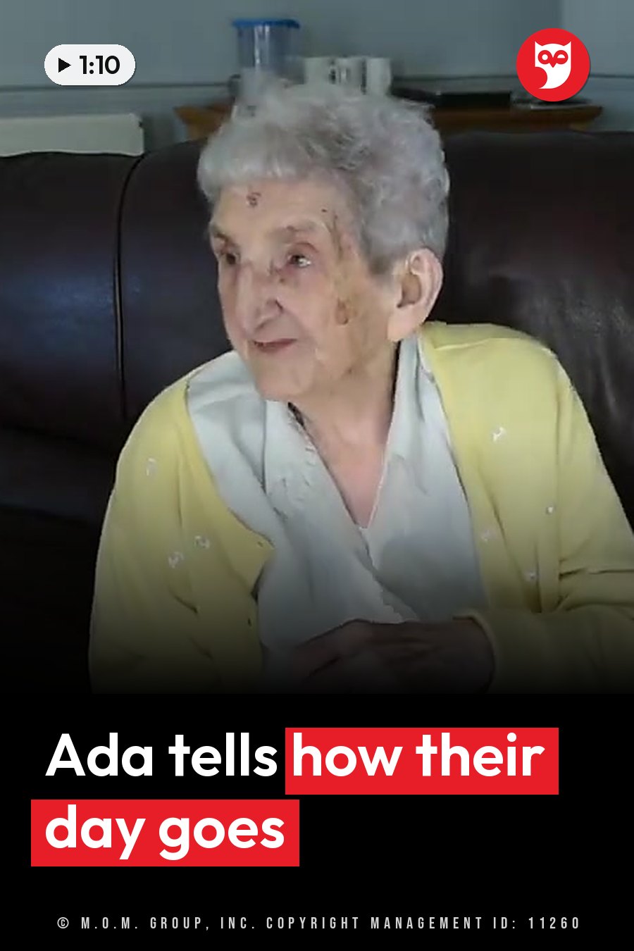An elderly woman with gray hair sits on a dark couch, wearing a yellow cardigan over a white shirt. A headline runs in white letters across the lower third.