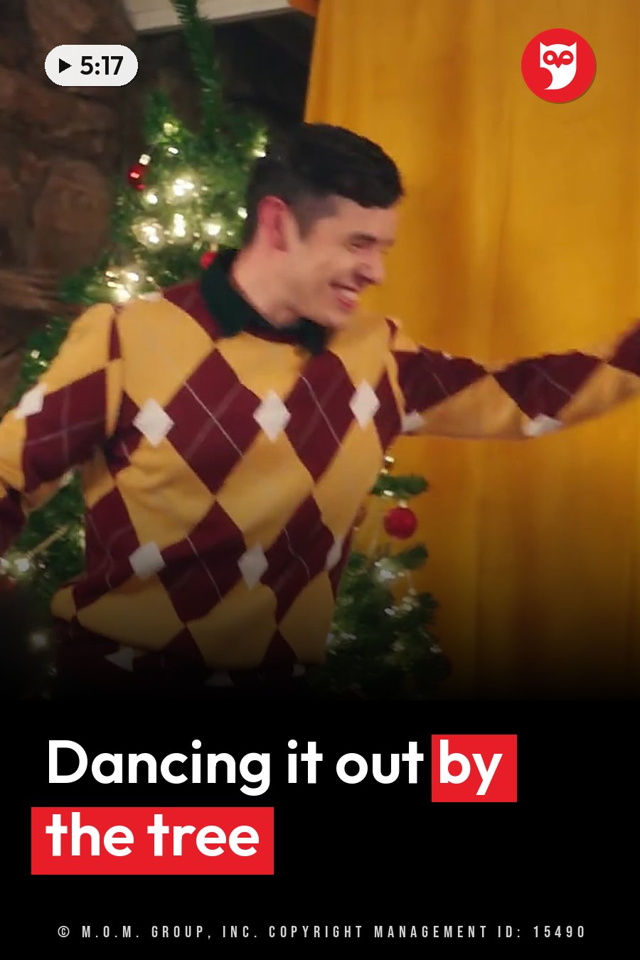 A man in an argyle sweater dances near a Christmas tree hung with lights and ornaments. A headline runs in white letters across the lower third.