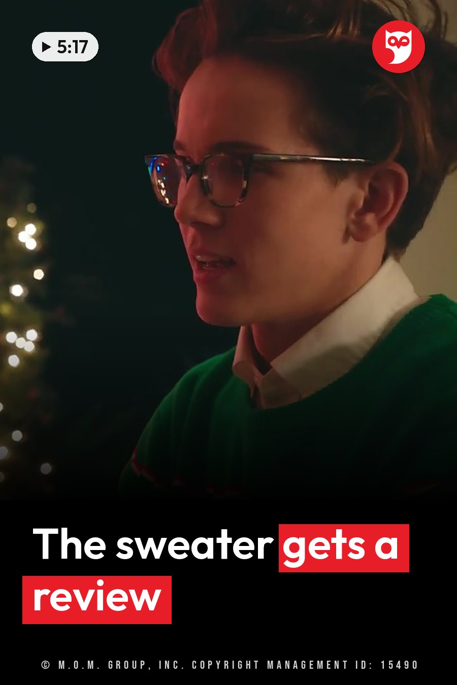 A young person with glasses, a green sweater and a white collar talks near a lit Christmas tree at night. A headline runs in white letters across the lower third.