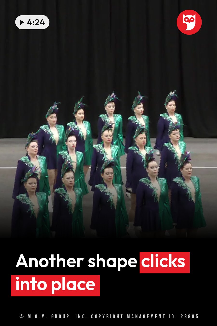A group of women in matching green and purple costumes stand on a stage, posing in feathered headpieces. A headline runs in white letters across the lower third.
