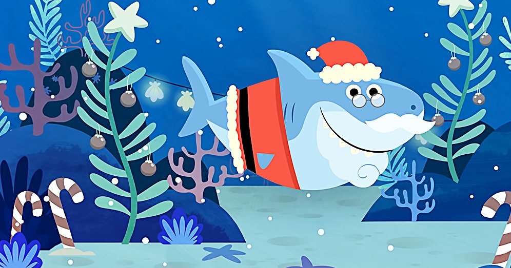 A cartoon shark wearing a Santa hat swims underwater among festive decorations including ornaments resembling Christmas tree baubles, candy canes, and starfish. The scene is bright with marine life elements suggesting it's during the holiday season.
