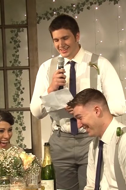 A wedding scene with a young adult female bride in a white lace bridal gown and two groomsmen in matching attire, set against an indoor venue decorated with fairy lights and greenery.