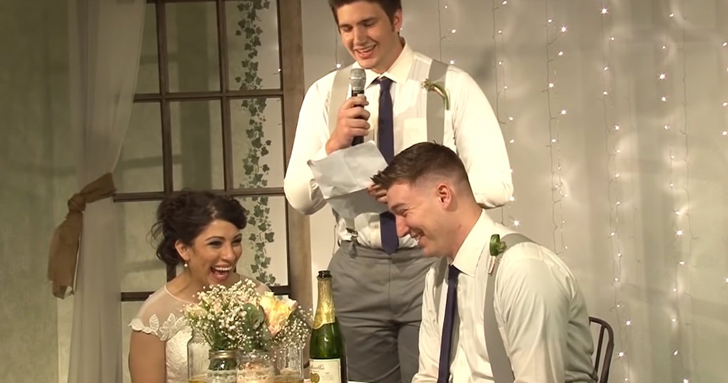 A wedding scene with a young adult female bride in a white lace bridal gown and two groomsmen in matching attire, set against an indoor venue decorated with fairy lights and greenery.