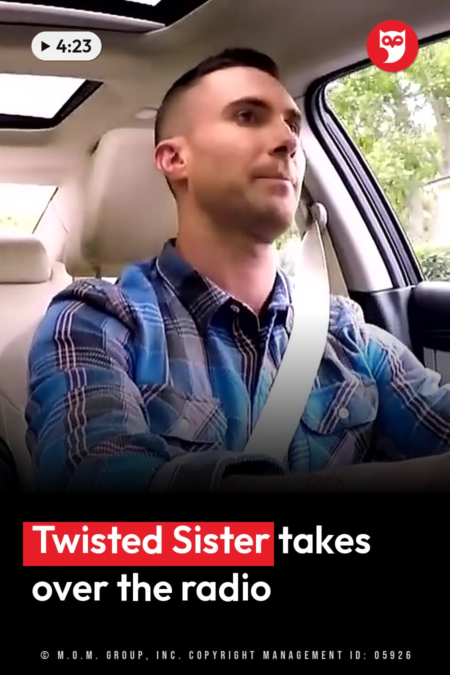 A man in a plaid shirt drives with his seat belt on and his eyes on the road ahead. A headline runs in white letters across the lower third.