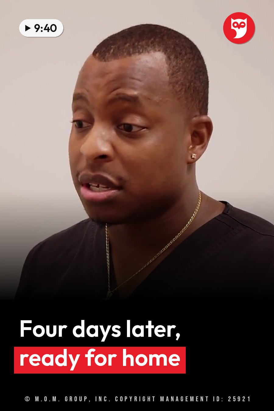 A man with short hair, a dark shirt and a gold chain looks slightly to his left as he speaks. A headline runs in white letters across the lower third.