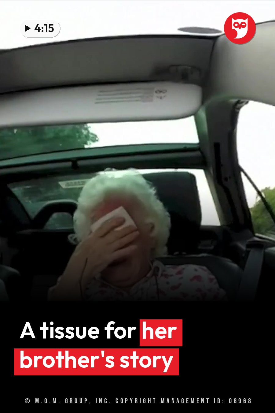 An older person sits in a car and wipes their face with a tissue. A headline runs in white letters across the lower third.