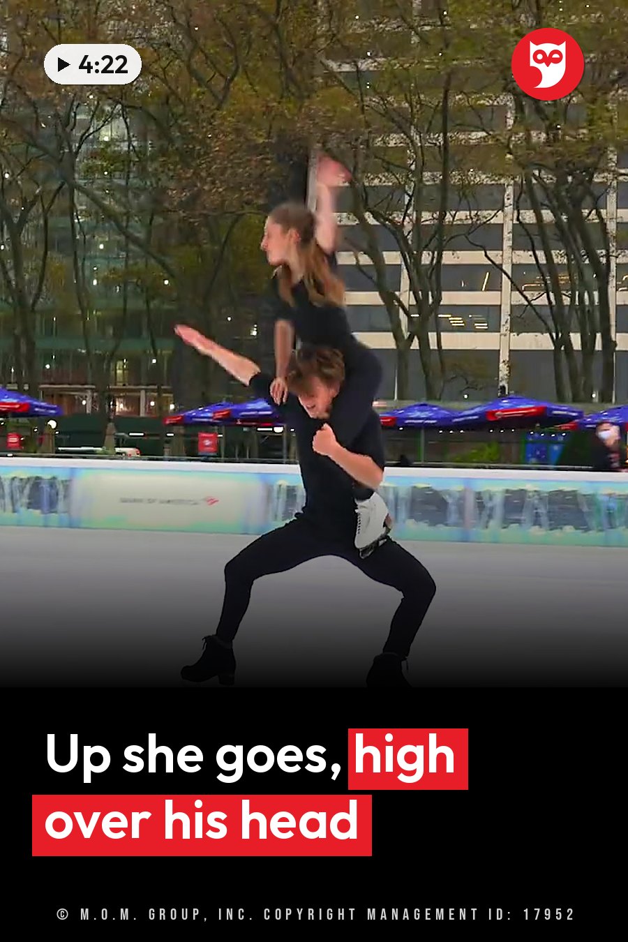 One ice skater lifts the other high overhead on a lit rink while it is still dark. A headline runs in white letters across the lower third.