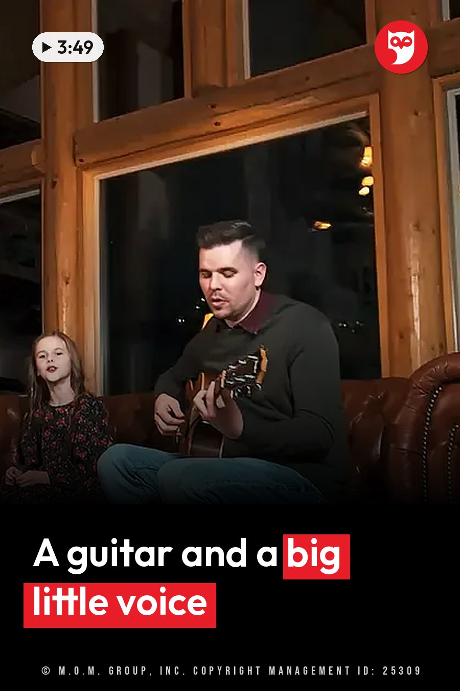 A man plays a guitar on a couch beside a young girl, with a large window behind them. A headline runs in white letters across the lower third.