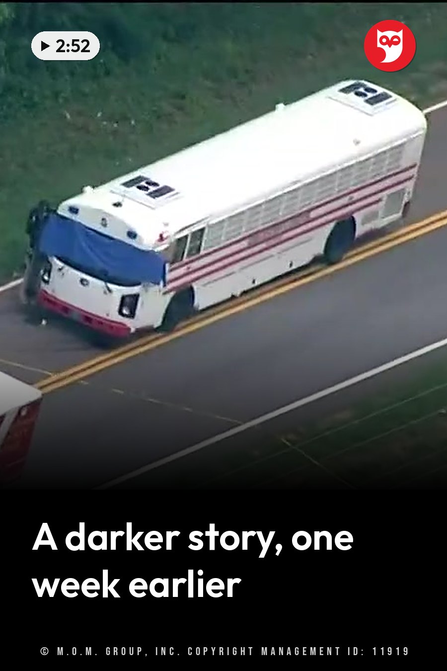 Aerial view of a white bus with red stripes driving on a road beside green grass. A headline runs in white letters across the lower third.