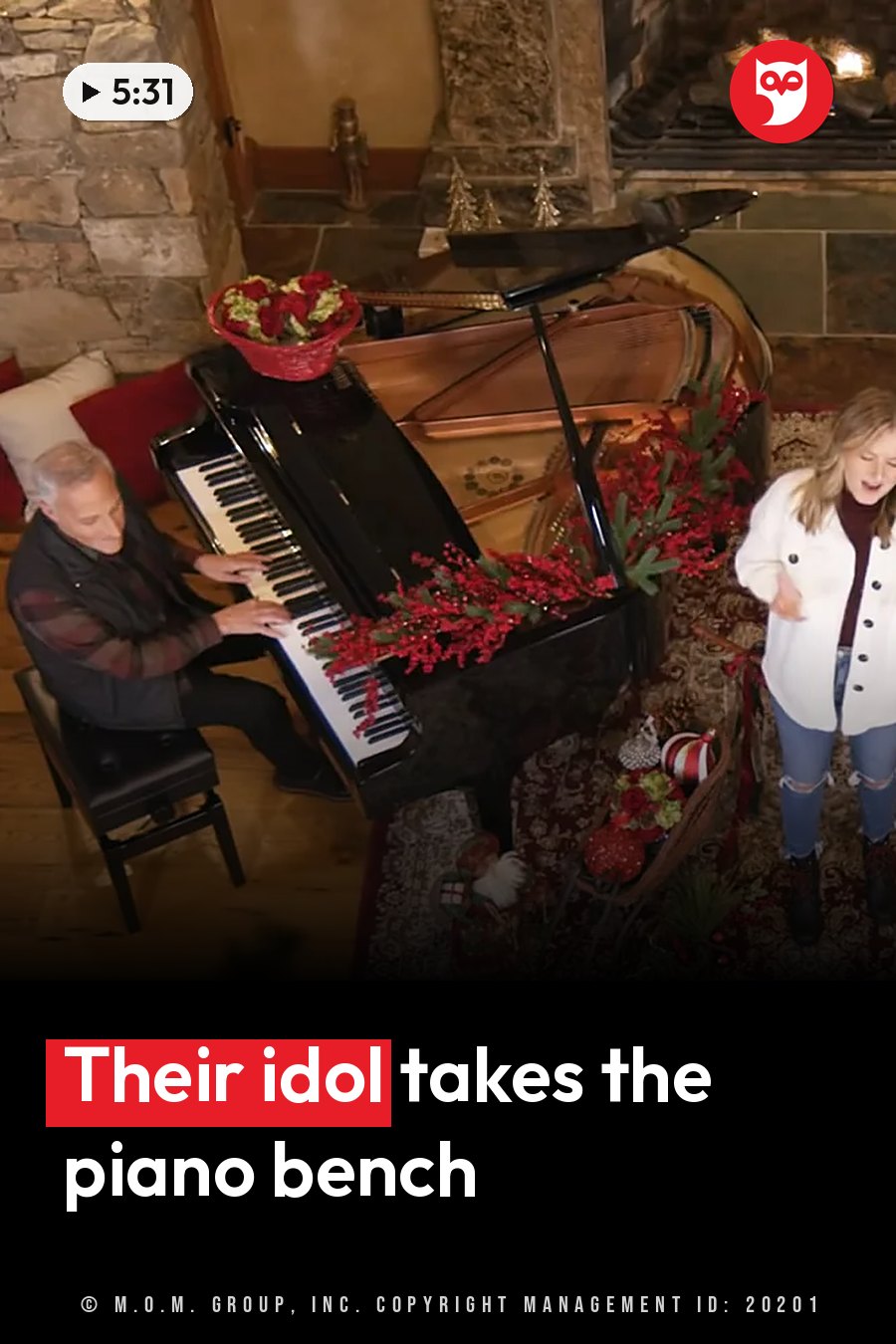 Jim Brickman plays piano while Savanna Shaw sings beside him near a fireplace decorated with red flowers. A headline runs in white letters across the lower third.
