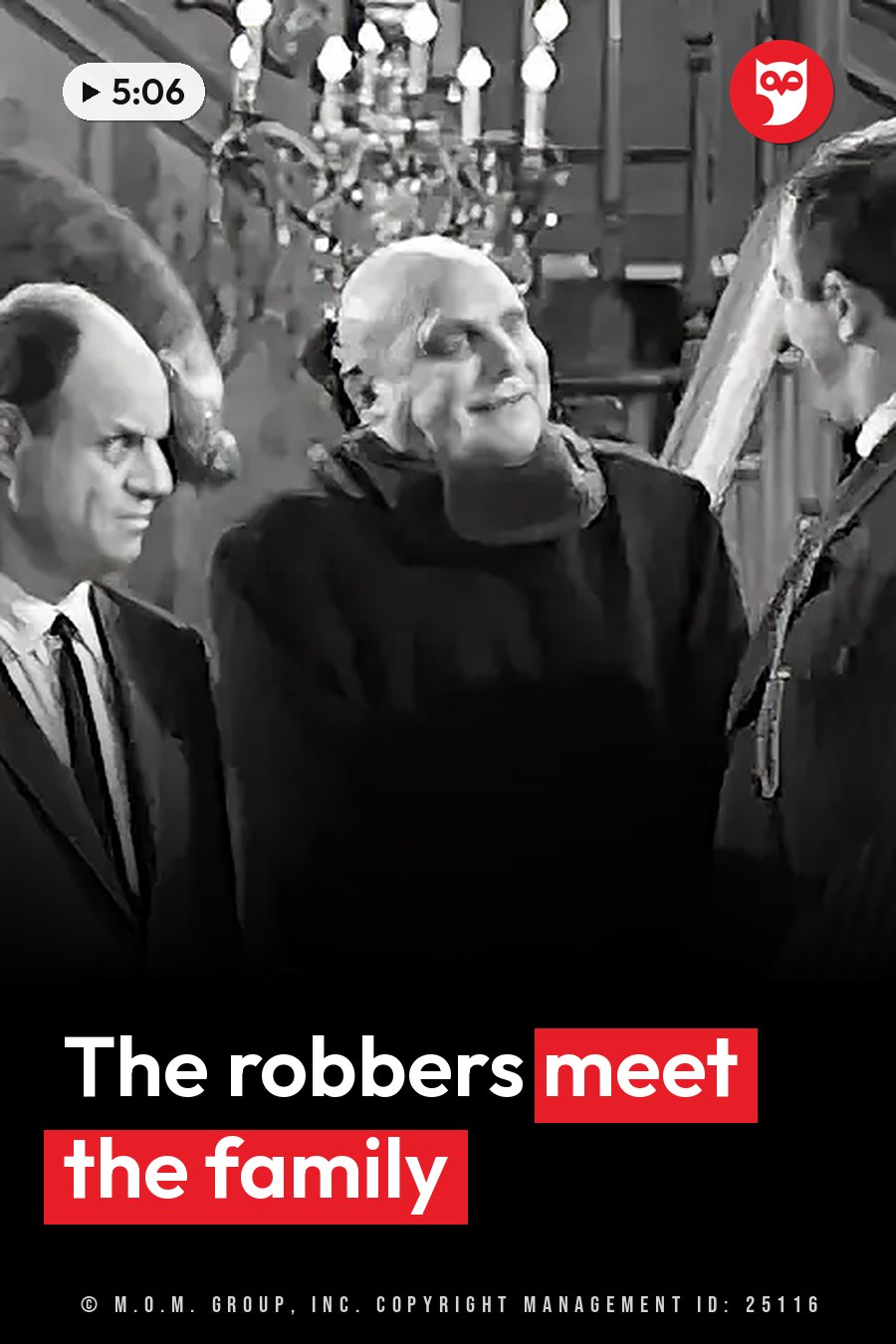 Three men stand indoors near a chandelier. One looks up and smiles while the other two face to the side. A headline runs in white letters across the lower third.