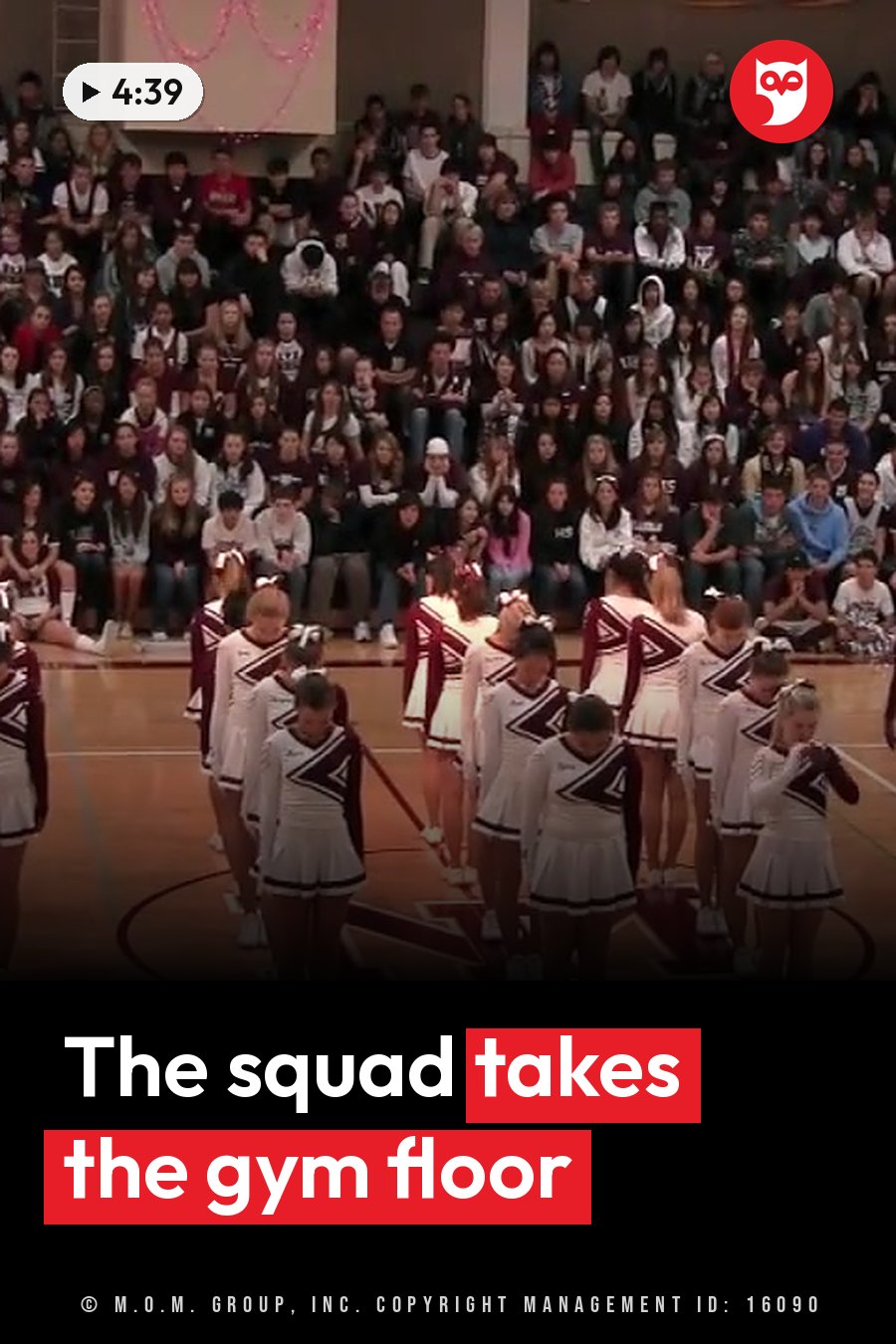 Girls in uniforms stand on a gym floor in front of an audience seated in bleachers. A headline runs in white letters across the lower third.