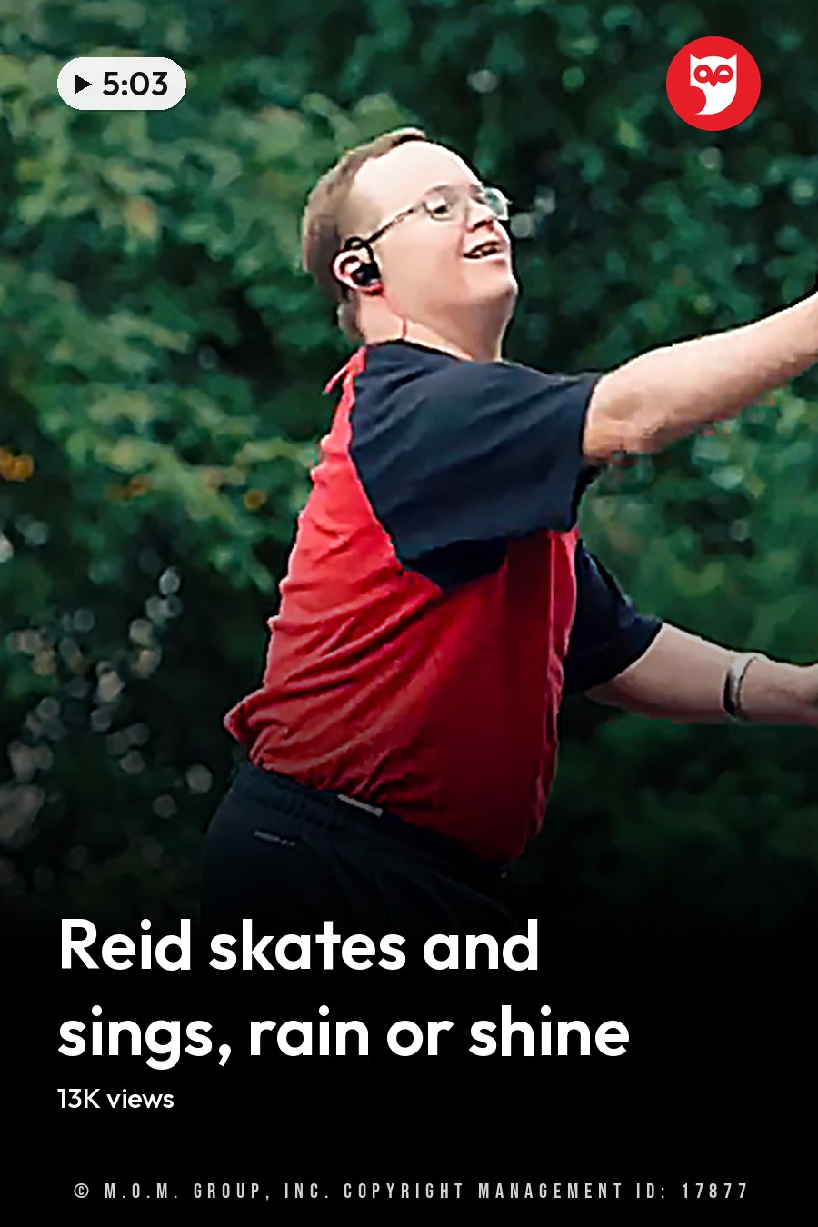 A young adult male wearing a red and black short-sleeved shirt with dark athletic or casual pants, glasses, a watch, and an earpiece in a park-like outdoor setting with green trees and soft lighting. The headline runs in white letters across the lower third.