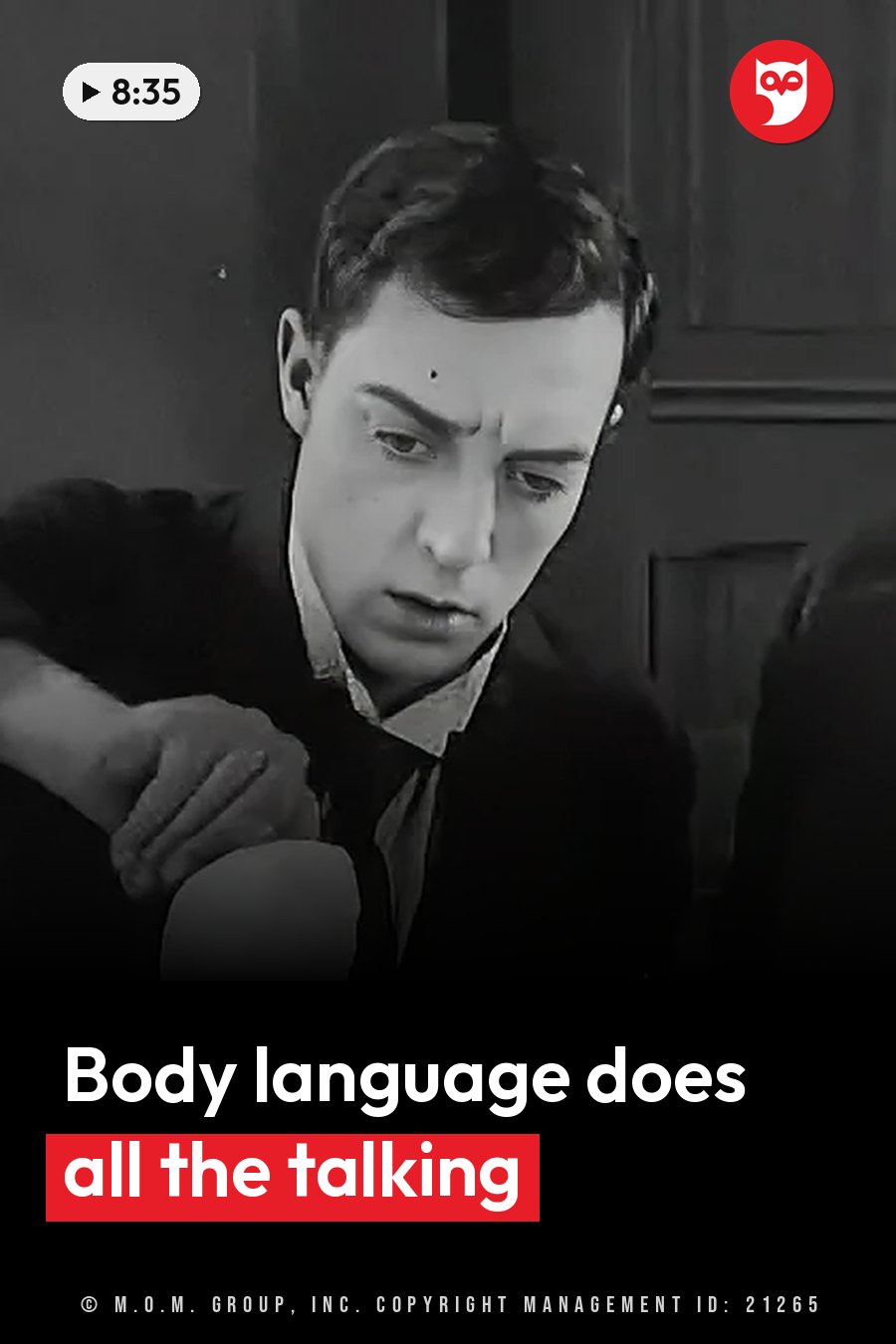 A man in a dark suit leans forward with one hand on an object, looking down intently. A headline runs in white letters across the lower third.