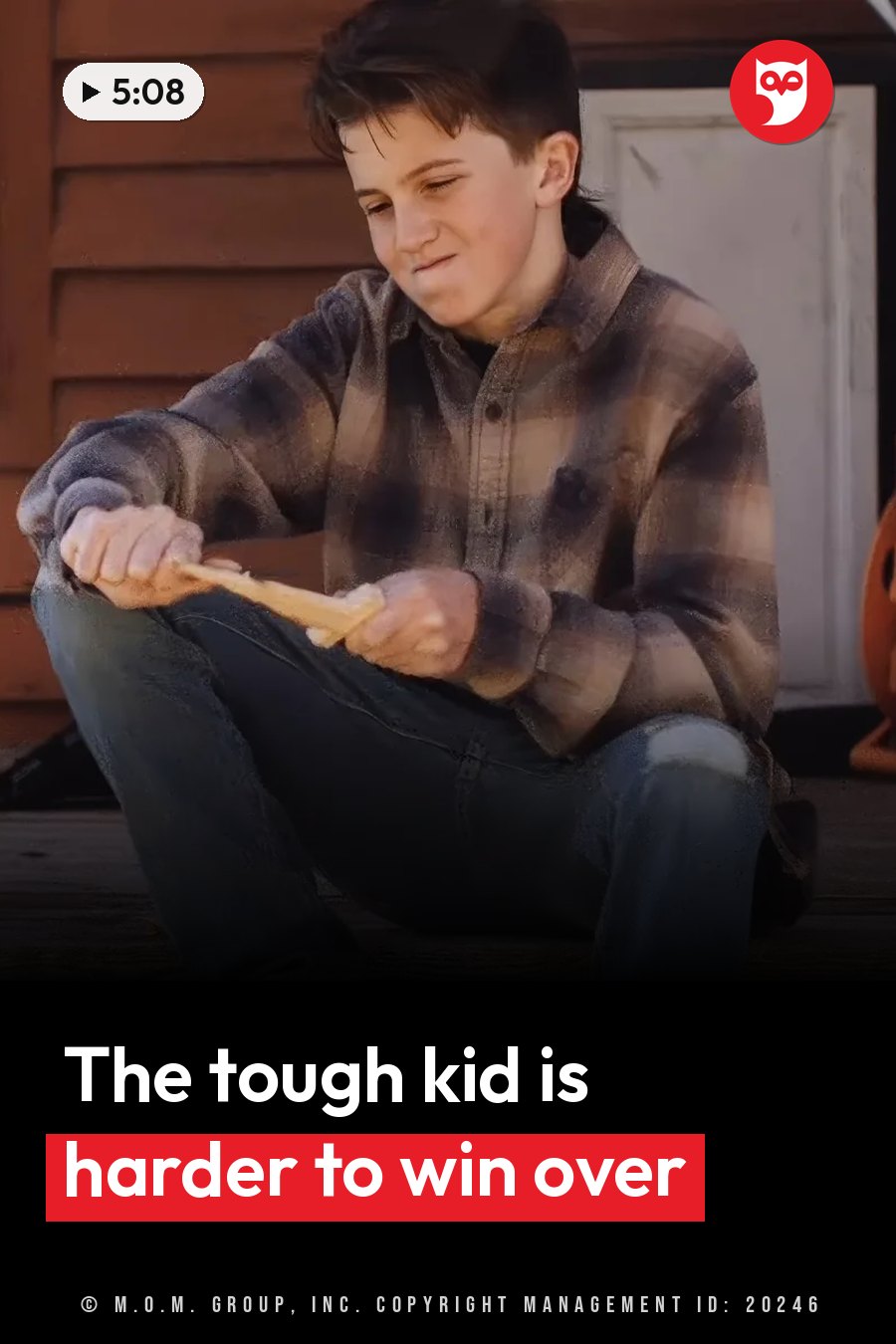 A boy sits on a porch, holding something long with both hands and eating it. A headline runs in white letters across the lower third.