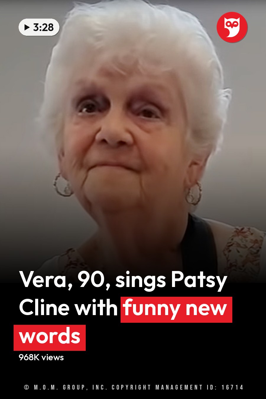 An older adult female wearing a floral-patterned top with a white cardigan or light jacket draped over her shoulders, holding a guitar strap around her neck in an indoor setting. The headline runs in white letters across the lower third.