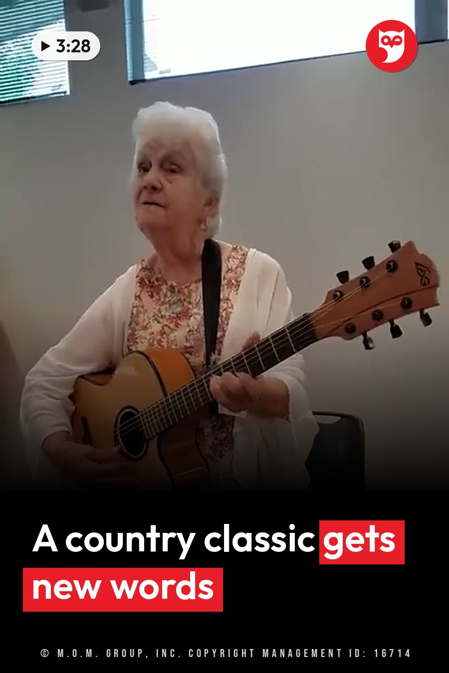 Vera, an older woman with white hair, plays an acoustic guitar while seated indoors near a window. A headline runs in white letters across the lower third.