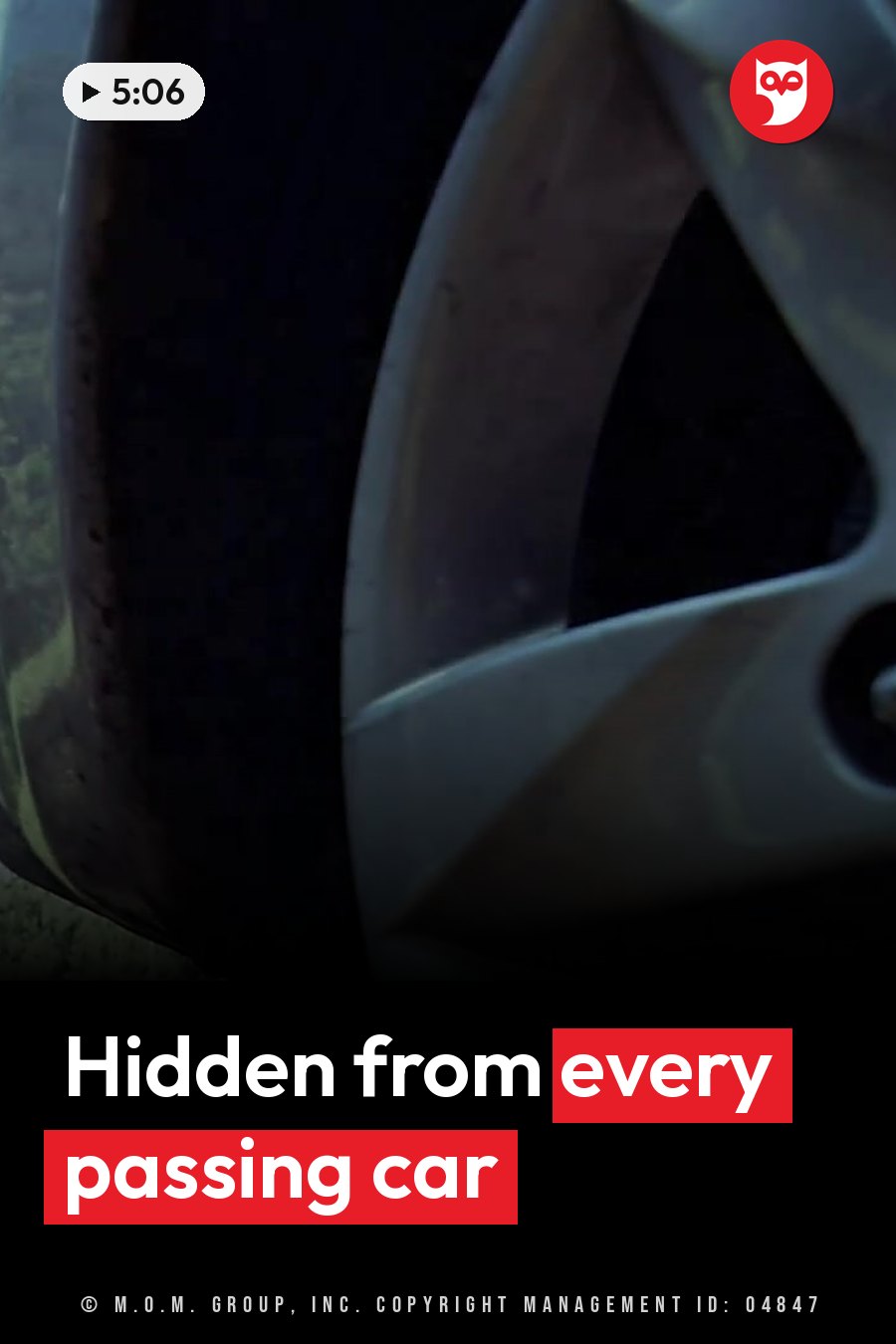 Close-up of a car wheel with a silver rim and a black tire, with scenery behind it partly hidden. A headline runs in white letters across the lower third.