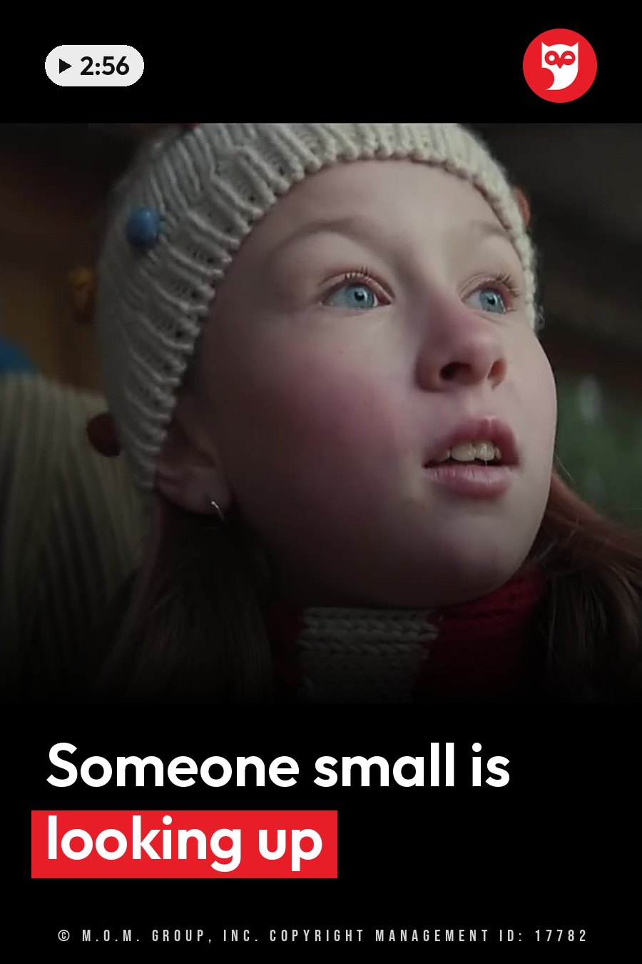 A young girl with blue eyes wears a knitted hat and scarf and looks upward. A headline runs in white letters across the lower third.