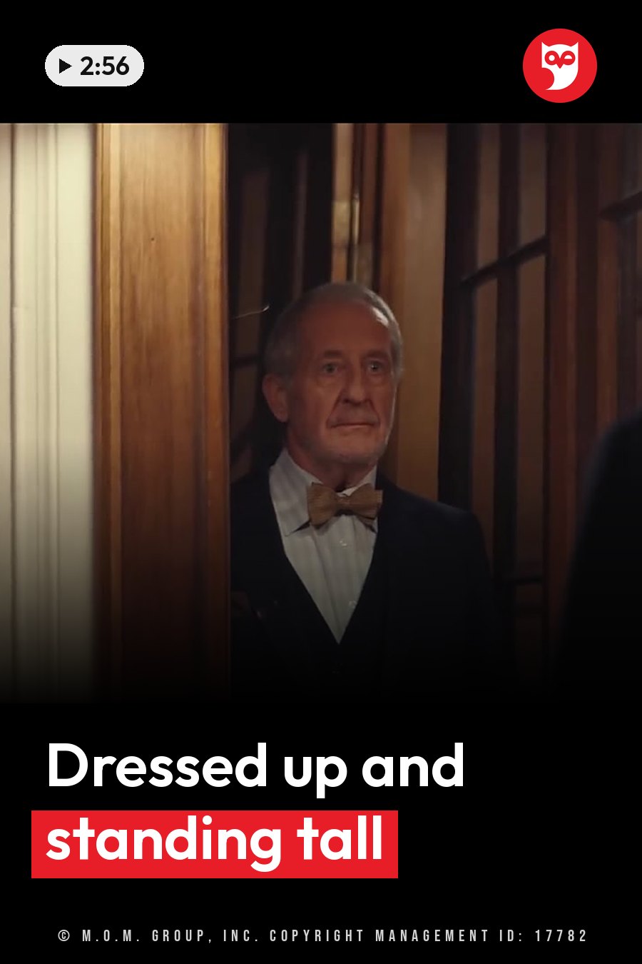 An older man in a suit and bow tie stands in a wooden doorway, looking forward. A headline runs in white letters across the lower third.