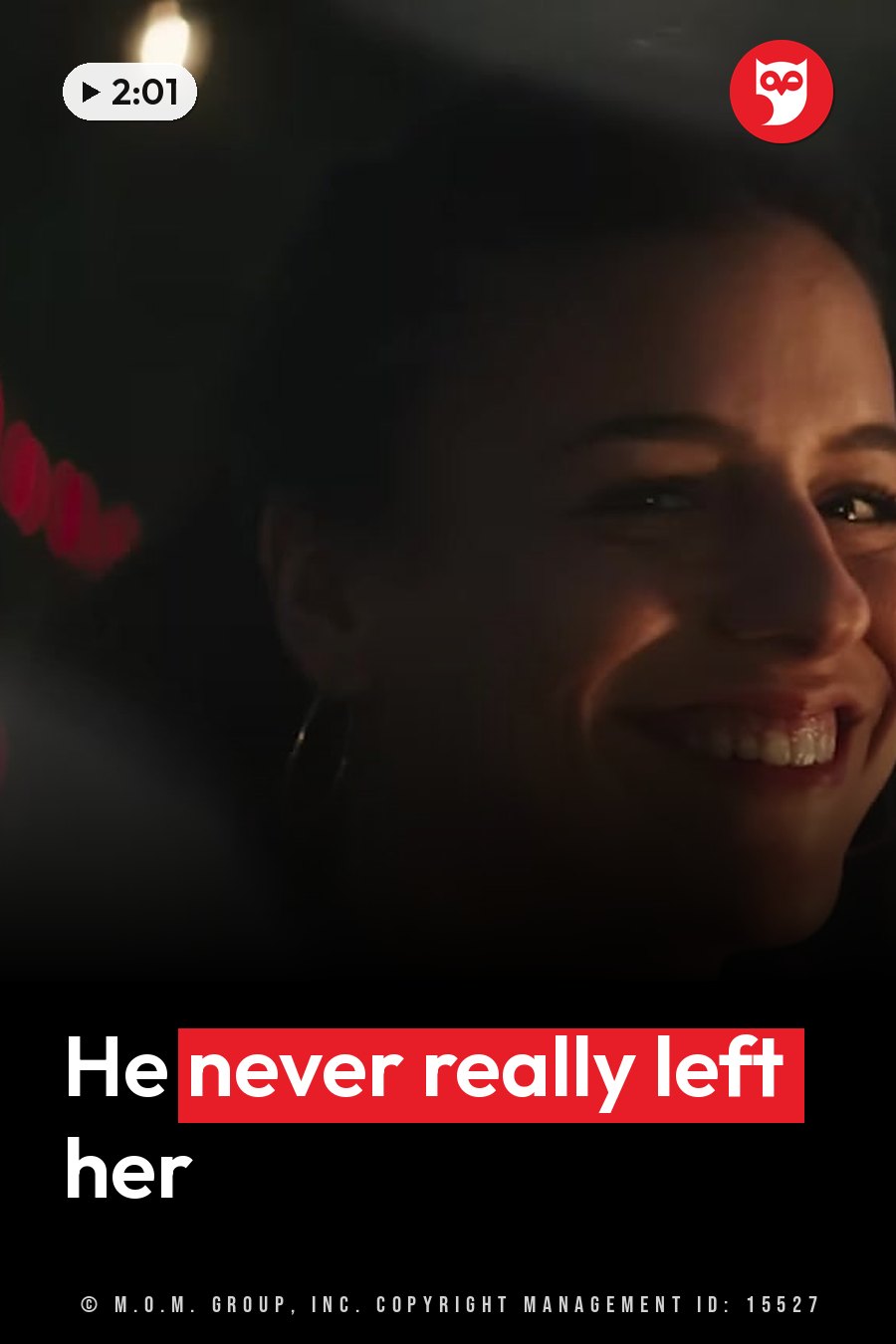 A woman smiles in dim light, with blurred red lights behind her and a bright bulb overhead. A headline runs in white letters across the lower third.