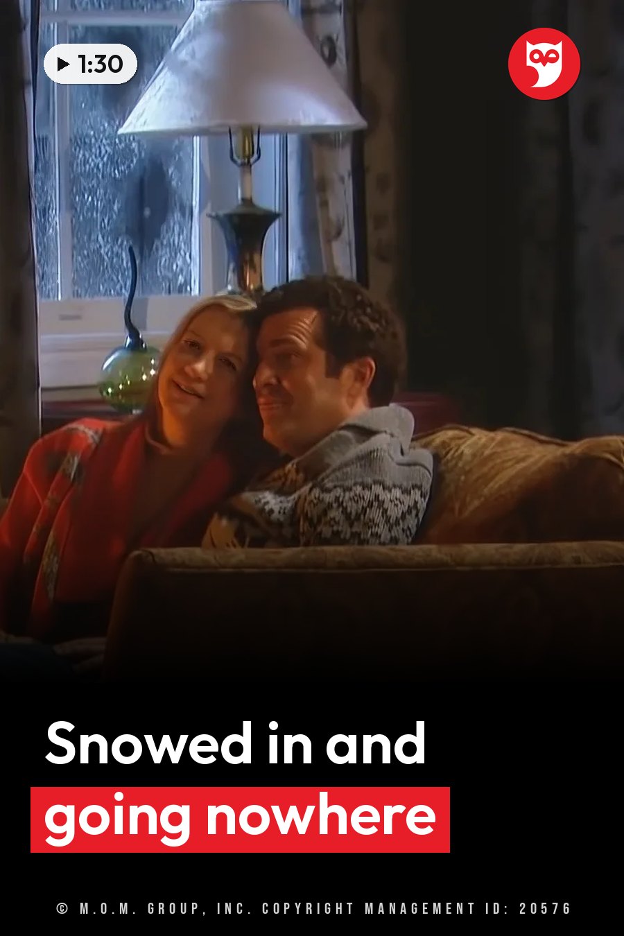 Two people sit close together on a couch near a lamp and a window with textured glass. A headline runs in white letters across the lower third.