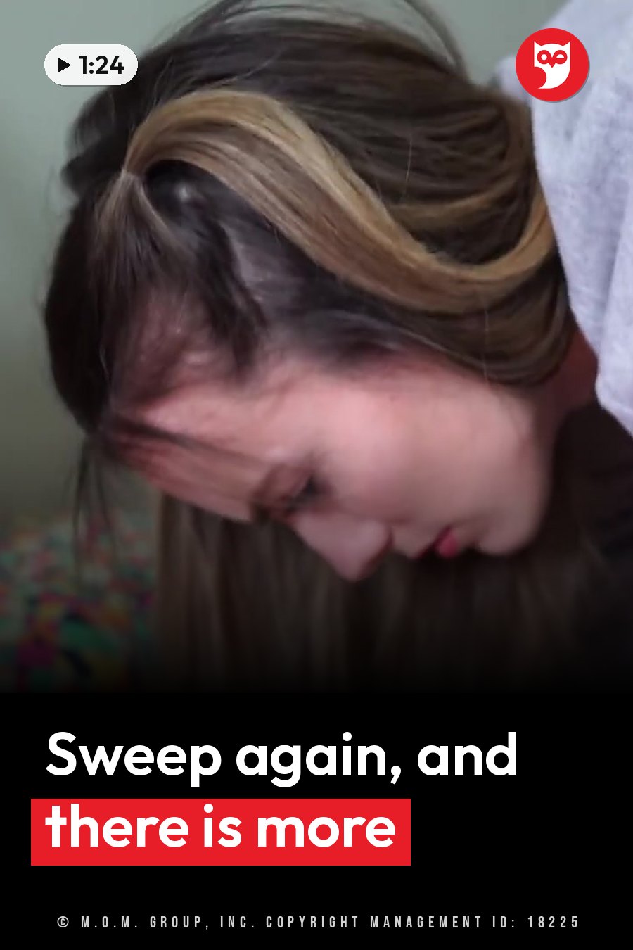 A woman with brown and blonde hair, wearing a white top, bows her head and looks at something below her. A headline runs in white letters across the lower third.
