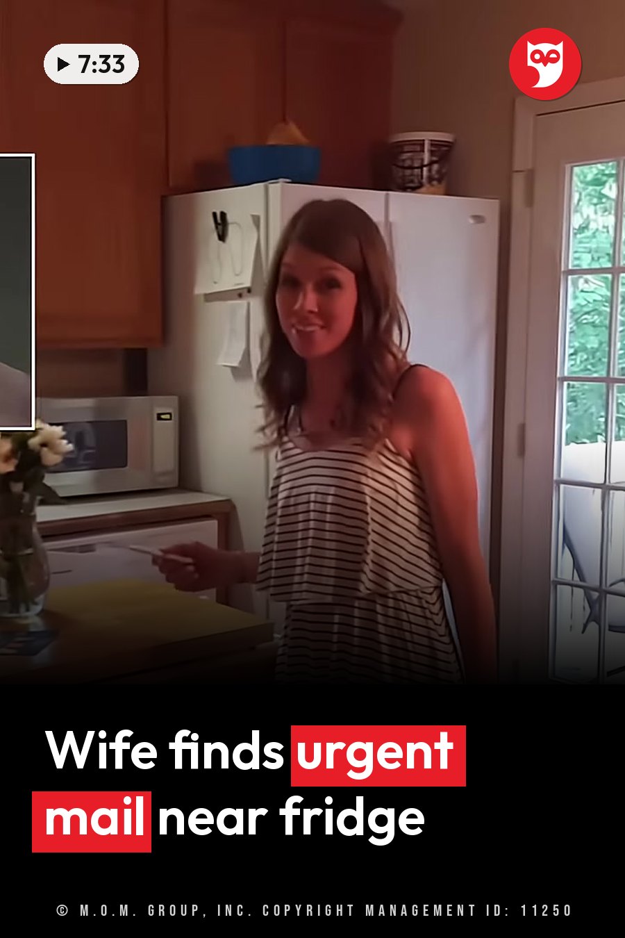 A woman stands in a kitchen holding an object near a refrigerator with papers stuck to it. A headline runs in white letters across the lower third.