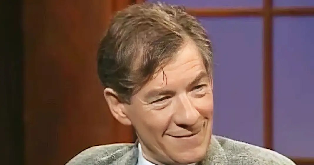 Middle-aged man in a tailored blazer with textured pattern, mid-20th century style, indoors studio setting with wooden paneling and soft lighting.