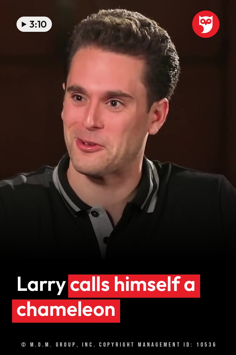 A man with short dark hair in a black polo shirt talks while looking slightly to his right. A headline runs in white letters across the lower third.