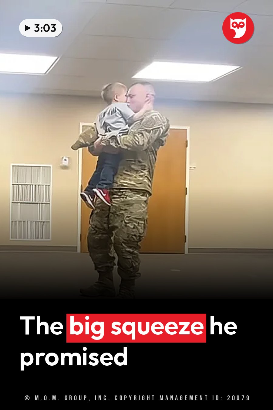 A man in a military uniform holds a small child close while standing indoors near a door. A headline runs in white letters across the lower third.