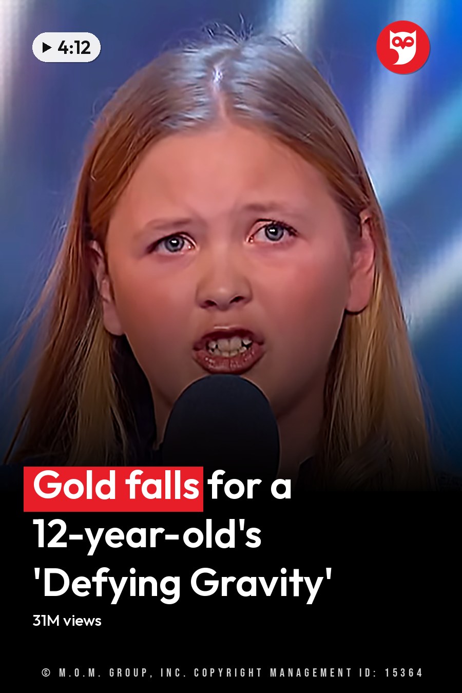 A young girl in a loose-fitting, dark blue star-patterned hooded garment performs on stage at what appears to be a talent show under bright indoor lighting with a colorful backdrop. The headline runs in white letters across the lower third.