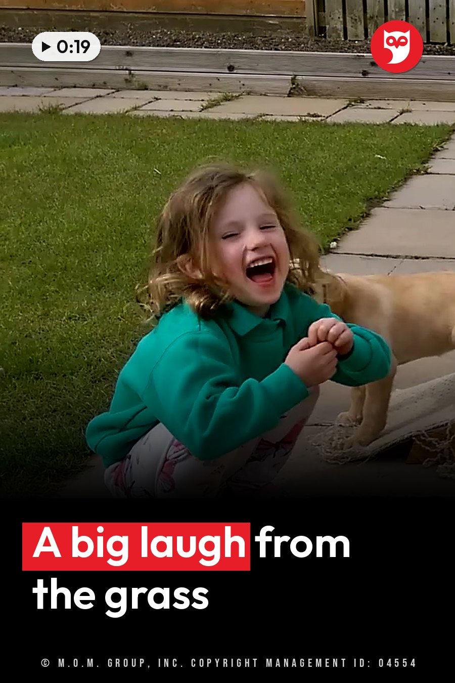 A young girl laughs while sitting on grass near a dog on a paved path. A headline runs in white letters across the lower third.