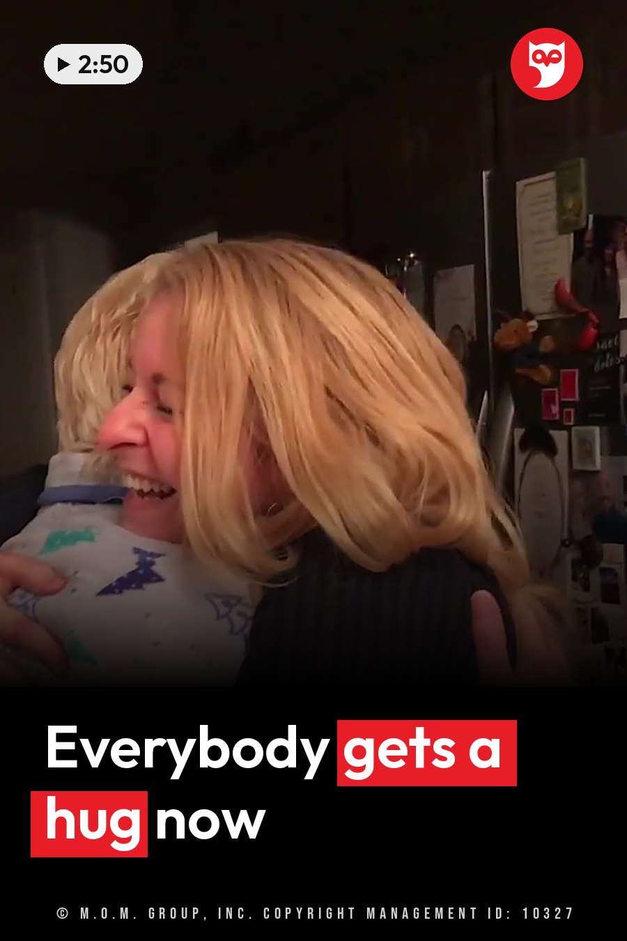 A woman with blonde hair hugs a child in patterned pajamas indoors, next to a refrigerator. A headline runs in white letters across the lower third.