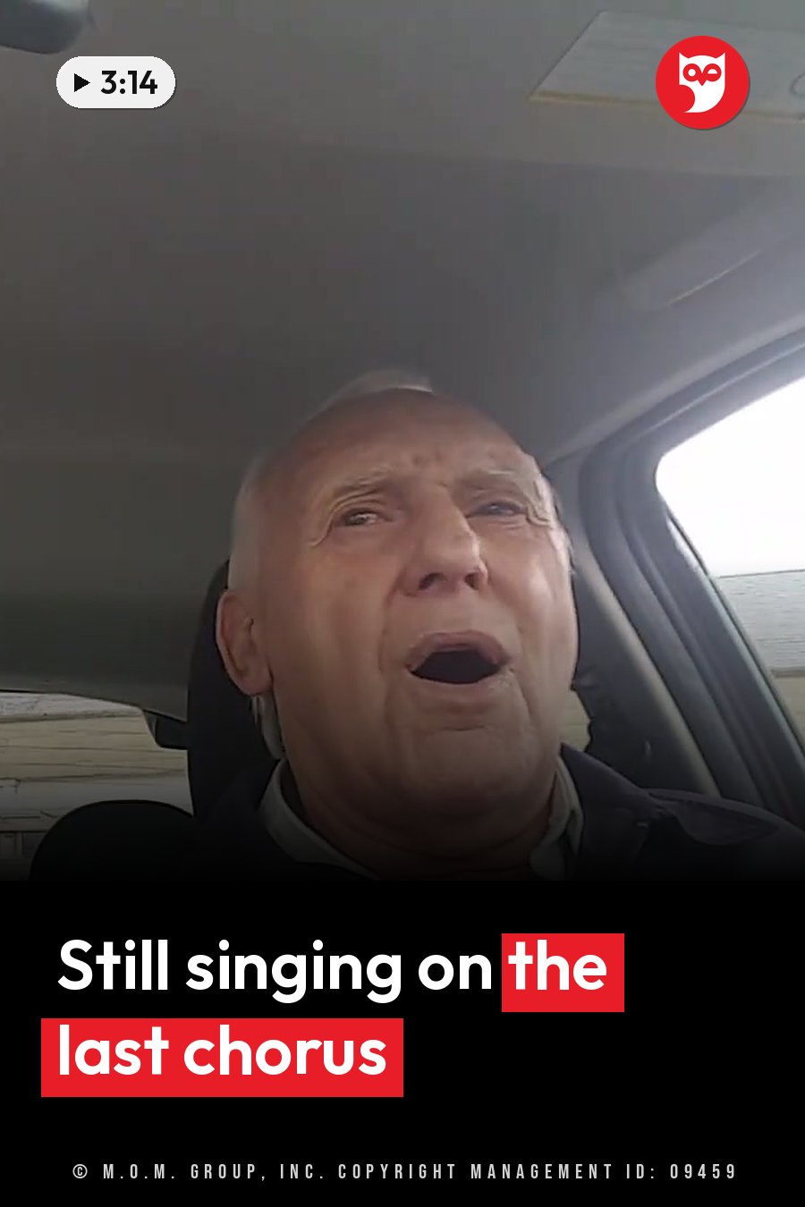 An older man sits in a car with his mouth open, as if speaking or singing. A headline runs in white letters across the lower third.