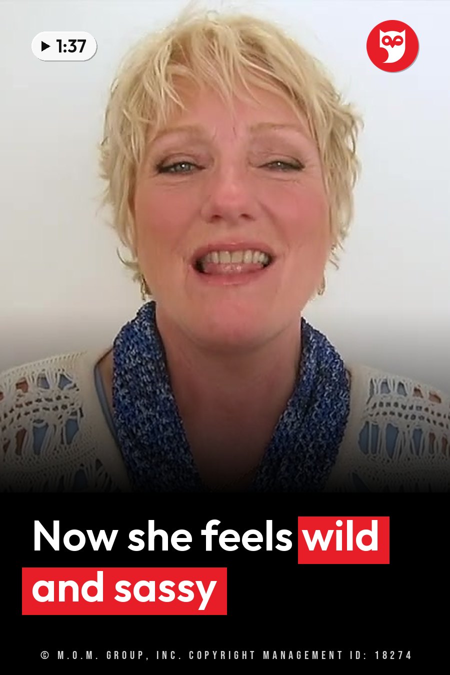 A woman with short blonde hair smiles broadly, wearing a blue scarf over a white crocheted top. A headline runs in white letters across the lower third.
