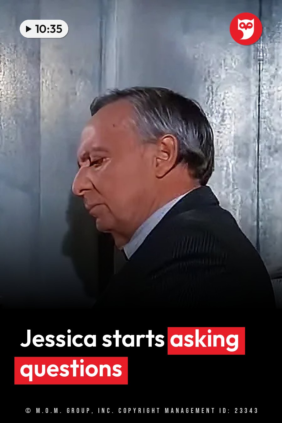 A man with gray hair in a dark suit stands sideways in front of a textured wall. A headline runs in white letters across the lower third.