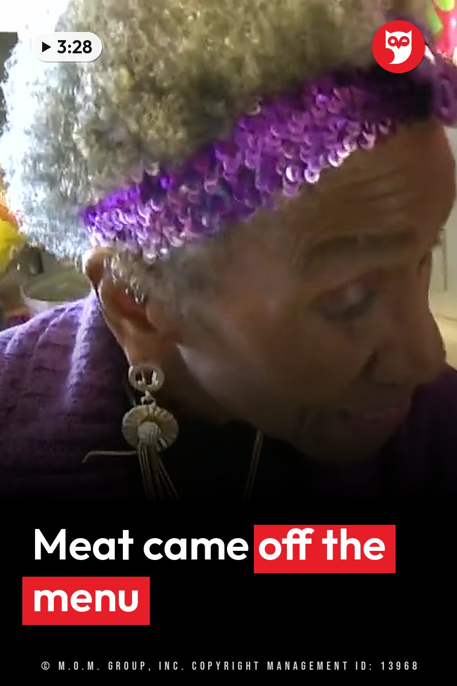 An older woman with gray hair, a purple sequined headband and large earrings looks down. A headline runs in white letters across the lower third.