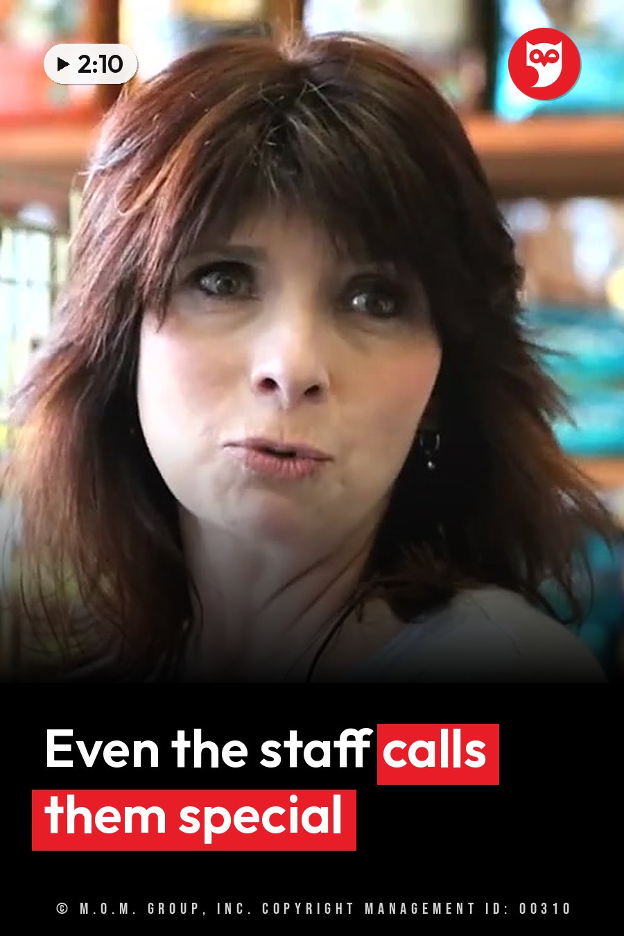 A woman with brown hair looks forward with her mouth slightly open, as if she is speaking. A headline runs in white letters across the lower third.