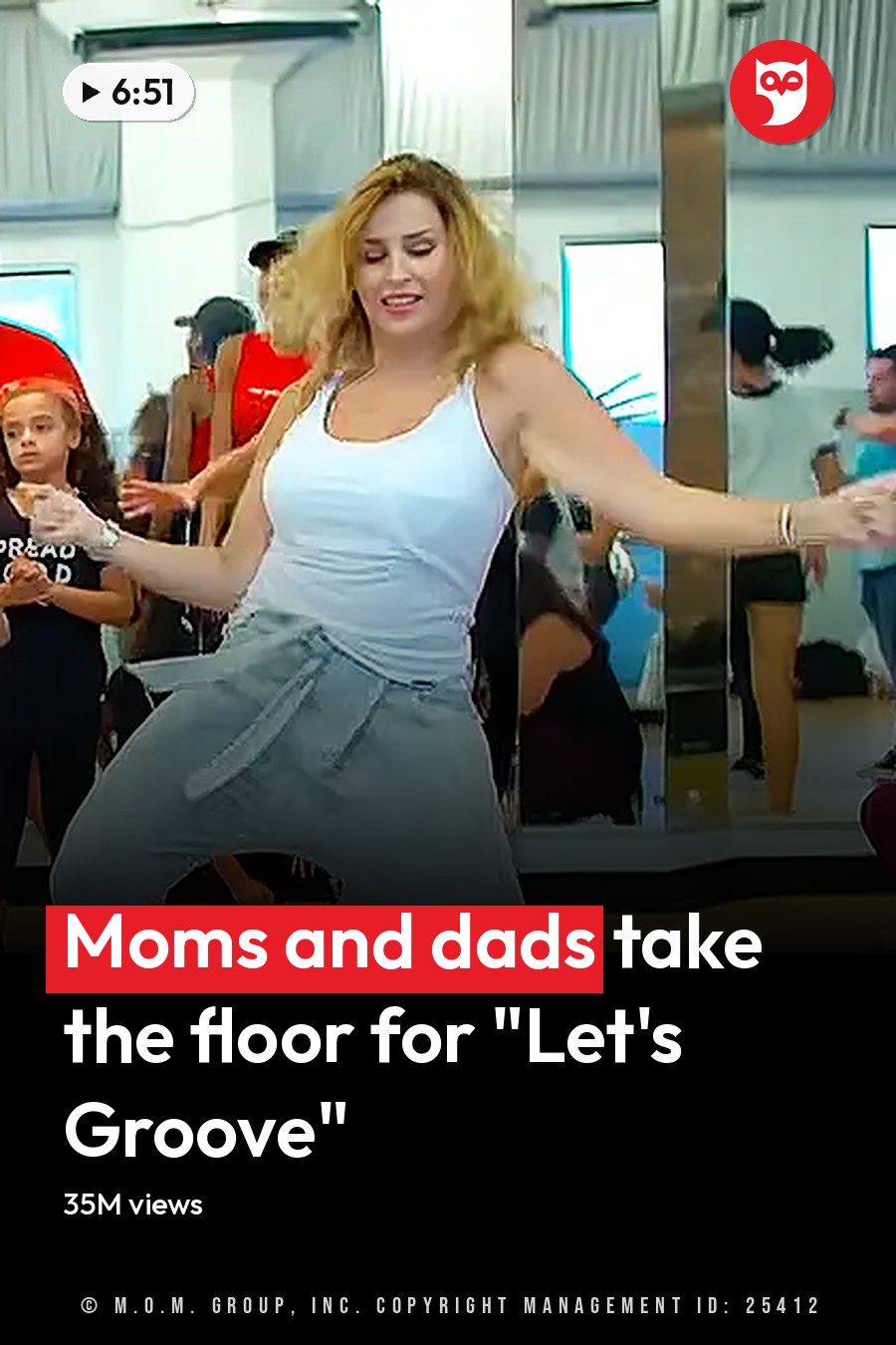 A dance class in progress at a fitness studio with various participants and mirrors reflecting the scene. The headline runs in white letters across the lower third.
