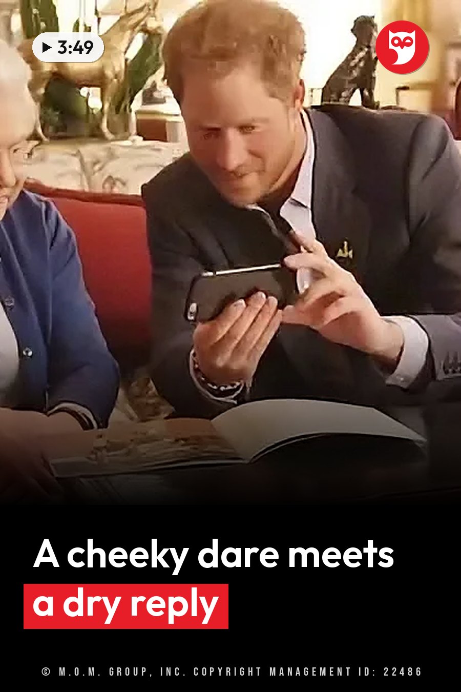 A man in a suit holds a phone while seated beside another person who looks at an open book on a table. A headline runs in white letters across the lower third.