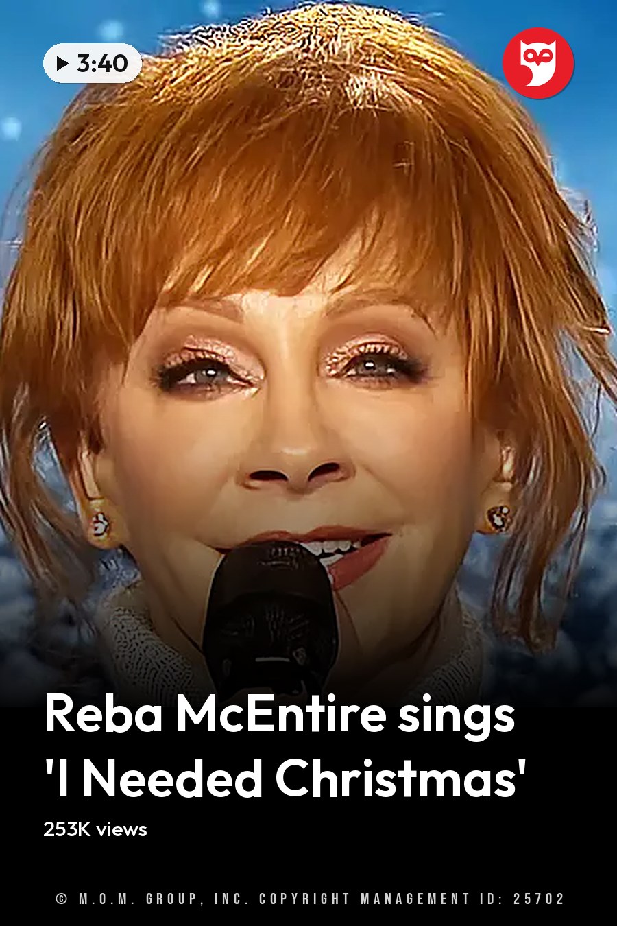 A middle-aged woman sings into a microphone against a snowy winter backdrop with clear skies. The headline runs in white letters across the lower third.