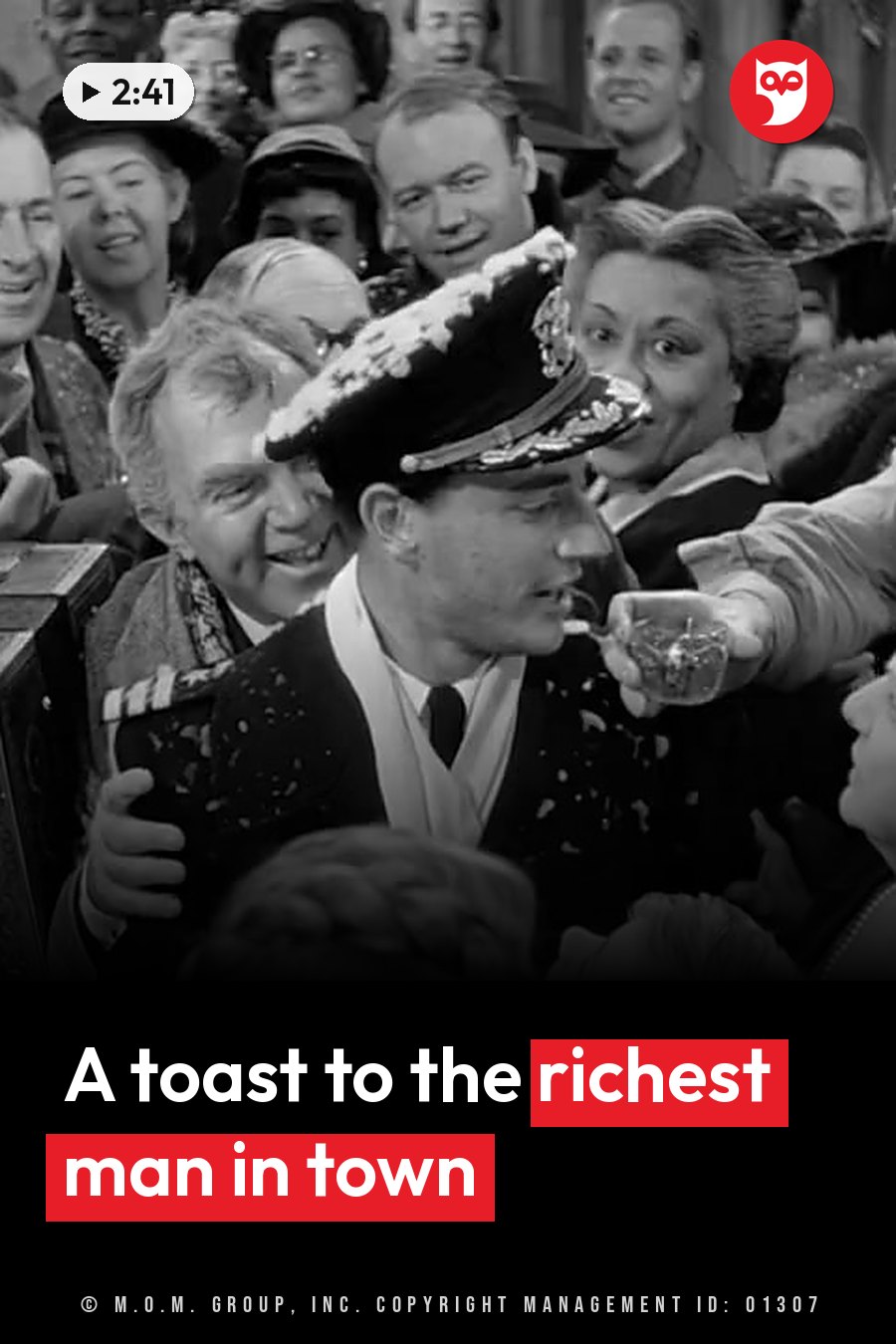 A man in a uniform drinks from a glass, surrounded by smiling people at a crowded gathering. A headline runs in white letters across the lower third.