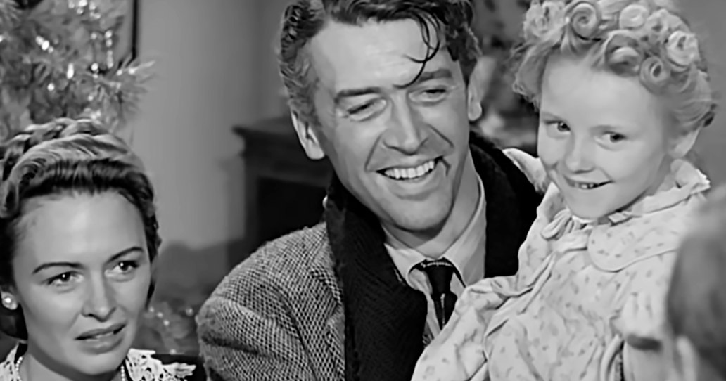 A family scene with a decorated Christmas tree indoors during the holiday season.